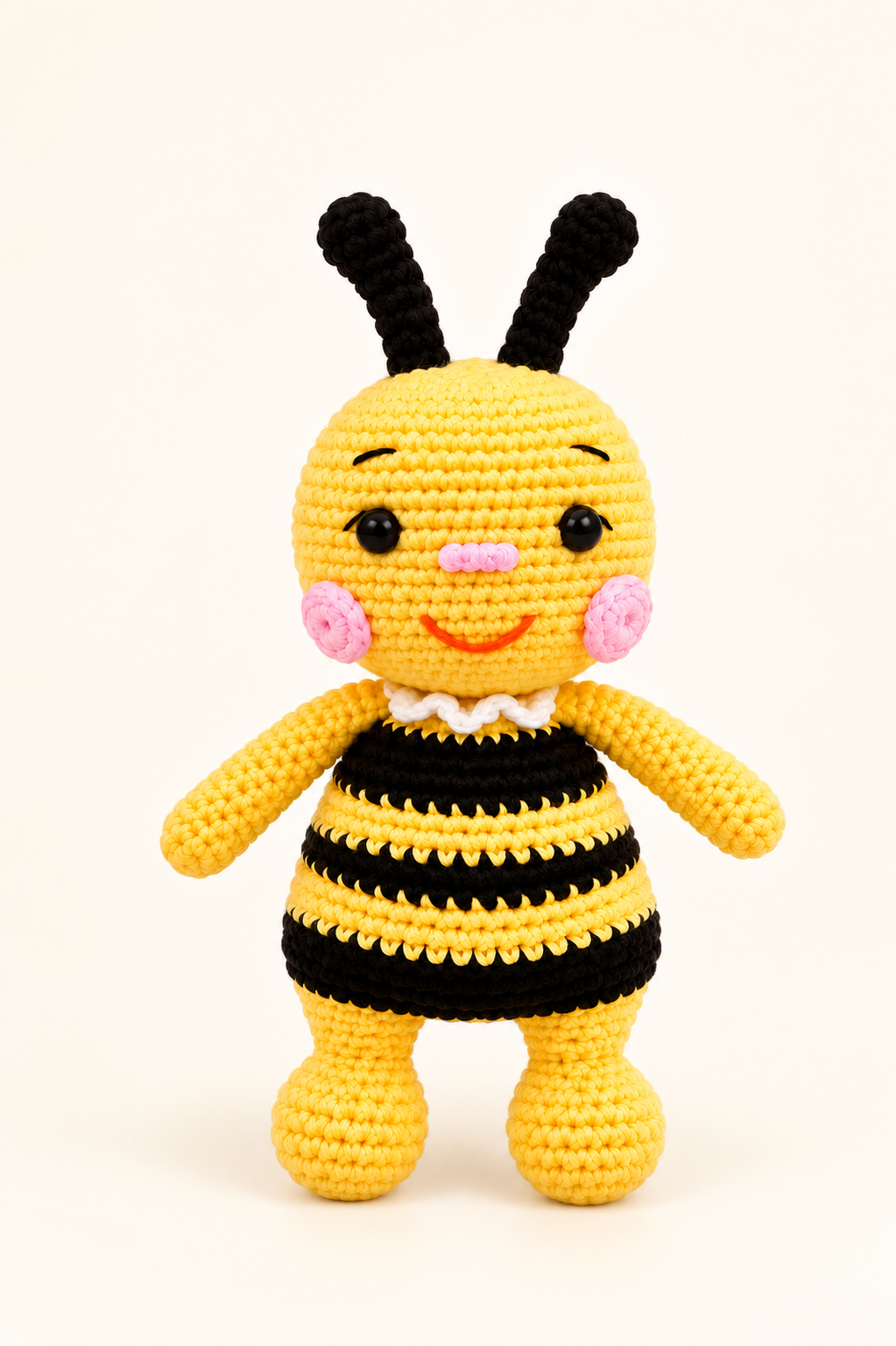 Yellow and black handmade crochet bee charm on a cream background
